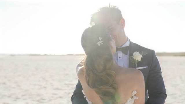 A wedding couple sharing a quiet moment beside the sea