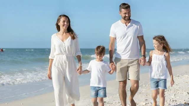 A family walking together beside the sea